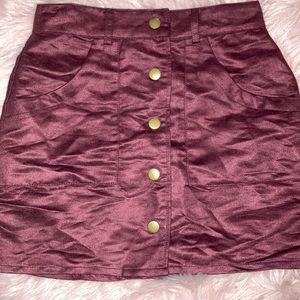A burgundy colored miniskirt in great condition.
